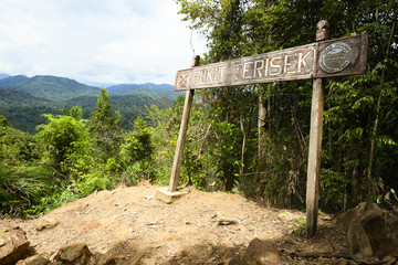 (Selective focus) Bukit Teresik signboard indicates the arrival at the viewpoint over the rainforest of the Taman Negara National Park. Kuala Tahan, Pahang State, Malaysia.