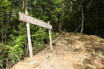 (Selective focus) Bukit Teresik signboard indicates the arrival at the viewpoint over the rainforest of the Taman Negara National Park. Kuala Tahan, Pahang State, Malaysia.