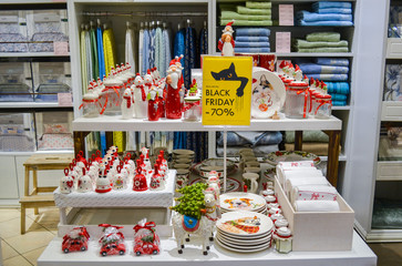 Moscow, Russia, November 2019: Sale in the store of goods for the house: dishes with Christmas ornament, interior decorations in red and white, the sign 