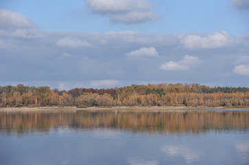 Autumn landscape with forest reflection on the lake in Poland.