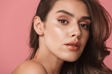 Obraz premium Portrait closeup of young shirtless woman looking at camera