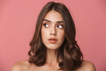 Naklejka premium Portrait closeup of elegant shirtless brunette woman looking aside