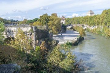Fototapeta na wymiar View of the Tiber Island and The Pons Aemilius (Ponte Emilio), today called Ponte Rotto , Rome Italy