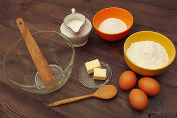 Natural ingredients for making dough on a wooden table.