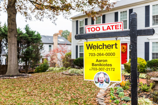 Herndon, USA - November 9, 2017: Too late real estate home buyer sign in front of house in Fairfax County, Virginia neighborhood with realtor name number, Weichert