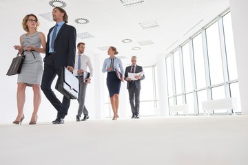 Business people walking in office hall