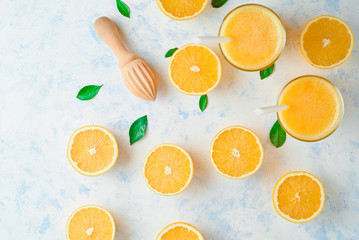 Fototapeta na wymiar orange juice in a glass, top view, slices of oranges, straw, healthy lifestyle concept