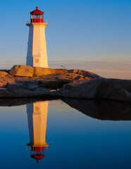 Peggys Cove lighthouse and reflection at sunrise