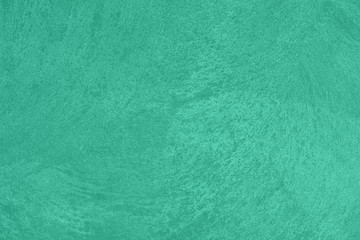 Trendy mint colored low contrast Concrete textured background with roughness and irregularities to your design or product. Color trend concept.