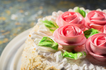 cake with roses close-up on a warm background. confectionery