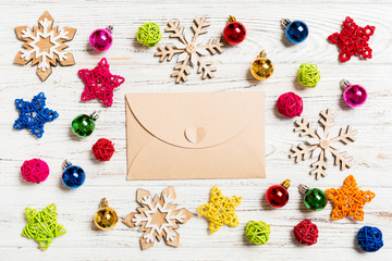 Top view of envelope on festive wooden background. Christmas toys and decorations. New Year time concept