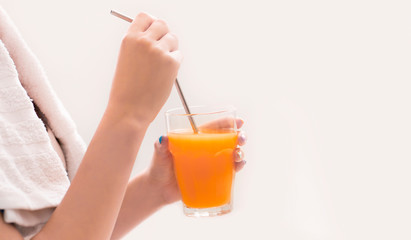 Woman drink orange detox fresh juice after training