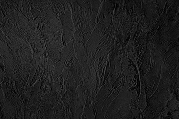 Black colored low contrast Concrete textured background with roughness and irregularities to your design or product.
