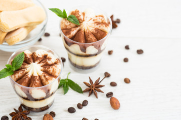 Tiramisu dessert with cocoa and mint in the glass