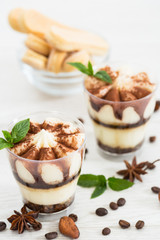 Tiramisu dessert with cocoa and mint in the glass