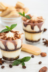 Tiramisu dessert with cocoa and mint in the glass