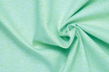 Crumpled fabric background texture, neo mint color, selective focus.