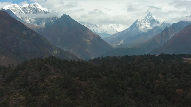 Ama Dablam and Taboche Mountains at Sunny Day. Himalaya, Nepal. Aerial View. Drone Flies Forward, Tilt Up