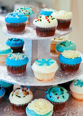 Blue and white cupcakes on a tray on the table