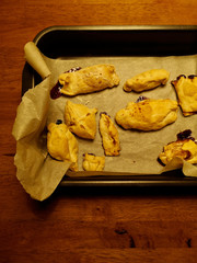 Homemade bakery dessert, cookies made by children. Top view of handmade ugly pastries on the pan