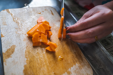 Closeup hand sliced ​​carrots on a chopping block