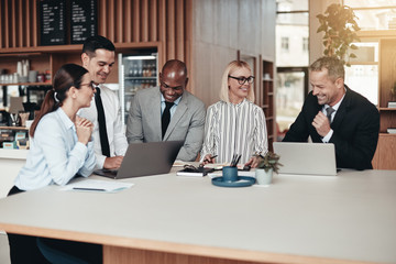 Diverse group of laughing businesspeople working in an office