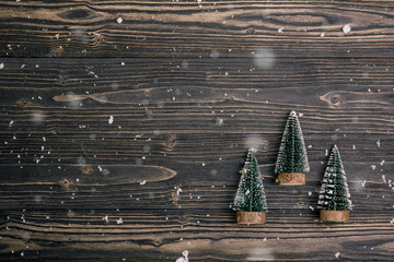 Naklejka premium Christmas holiday composition decoration with pine tree on wooden background, new year and xmas or anniversary with presents on wood table in season, top view or flat lay.