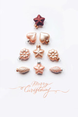 Creative composition of a Christmas tree from decorative ornaments. Lettering Merry Christma Flat lay, pastel. Minimalism.
