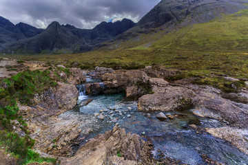 Small waterfall and creek along the walking route of The Fairy Pools in Glen Brittle on the Isle of Skye , Scotland