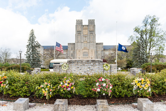 Blacksburg, USA - April 18, 2018: Historic Virginia Tech Polytechnic Institute And State University College Campus With Burruss Hall Facade Exterior And Memorial Flowers