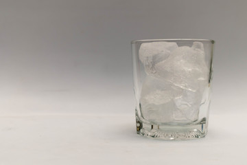 Close up, the ice is in a glass without water.