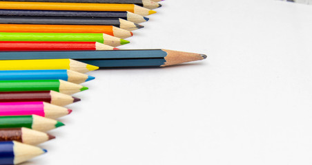 Many colored pencils, arranged in beautiful orderly on a white background