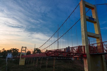 Fototapeta na wymiar The bridge over the river when the sunset