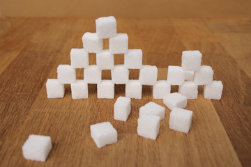 partially broken sugar cubes made from sugar cubes, refined slices, concept of excess sugar...