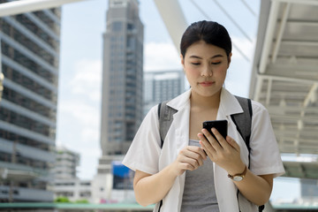 Traveler pretty blissful girl use smartphone check location while walking around the city