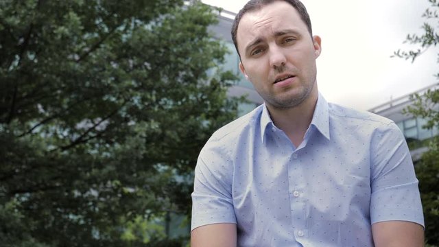 Man looks at the camera and talks.