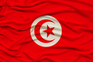 beautiful photo of the national flag of Tunisia on delicate shiny silk with soft draperies, the...