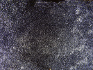 Used sandpaper closeup of texture with oblique lighting.