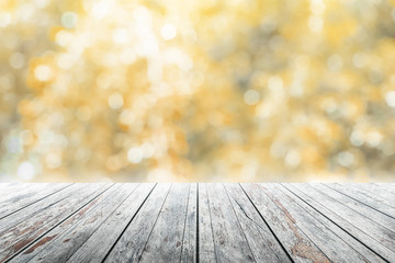 Empty wooden table in party with golden background blurred.