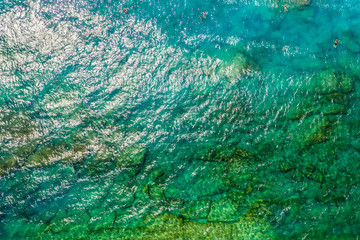 transparent bottom and clear sea with turquoise water on the beach of island in Greece, top view...