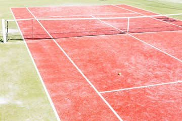 Fototapeta premium High angle view of empty red tennis court on sunny day