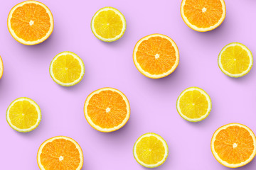 pattern of fresh orange slices and lemon on colored background. Citrus fruit pattern top view.