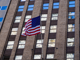 Close-up of the American flag of the United States. Stars and stripes honing over a building in New York City. United States of America.