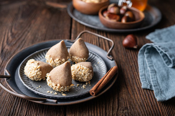 Traditional Korean no bake Yullan chestnut treat with honey and cinnamon, dipped in chopped peanuts