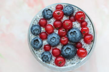 Chia seed pudding with blueberries and red currant berries in a glass