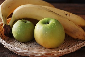 Green apples and bananas on the table