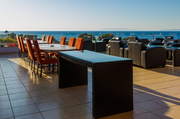 bar on balcony of the resort overlooking the sea, the setting sun, Greece, Europe.