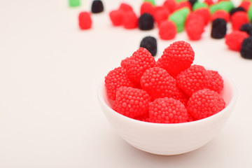 raspberry shaped candies scattered on the table