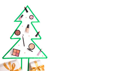 Christmas tree made of winter face care cosmetics on white