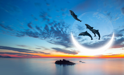 Group of silhouette dolphin jumping up from the sea at sunset with super moon 
